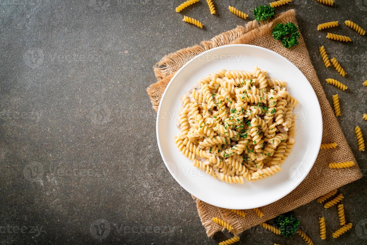 Spirali o salsa de crema de champiñones de pasta con perejil - estilo de comida italiana foto