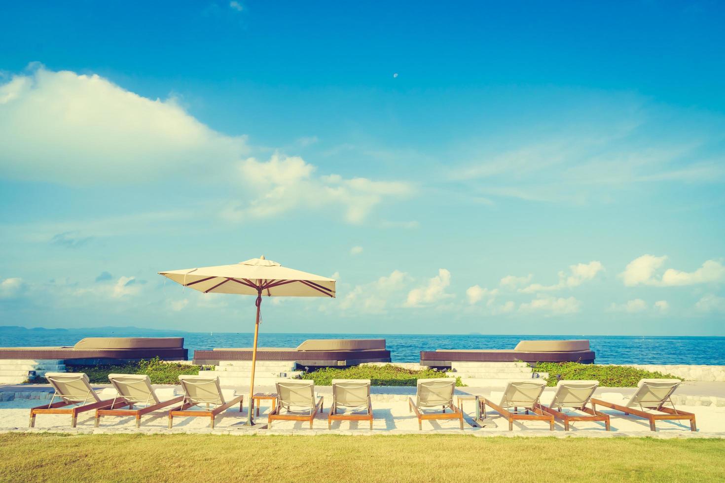 Umbrella and chair with sea view photo