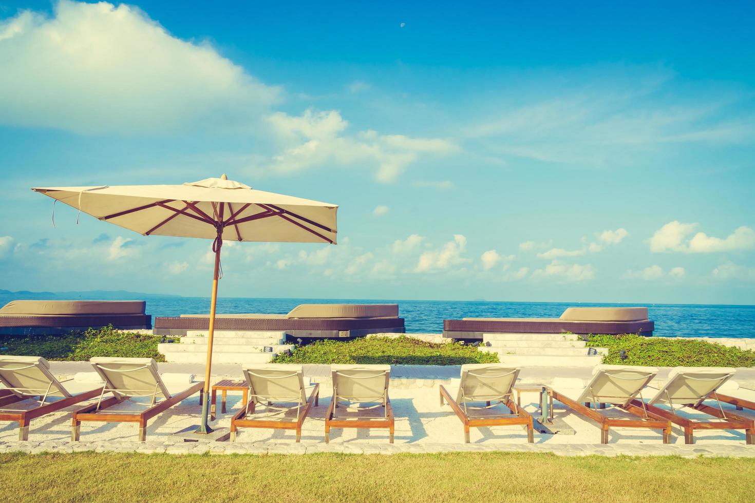 Umbrella and chair with sea view photo