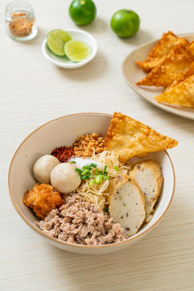 Spicy egg noodles with fish balls and shrimp balls without soup - Asian food style photo