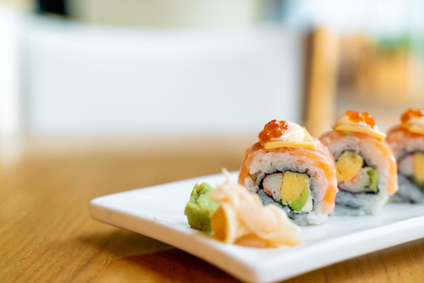 Salmon roll sushi with cheese on top - Japanese food style photo