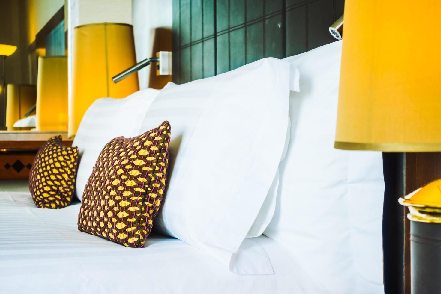 Pillow on bed with light lamp photo