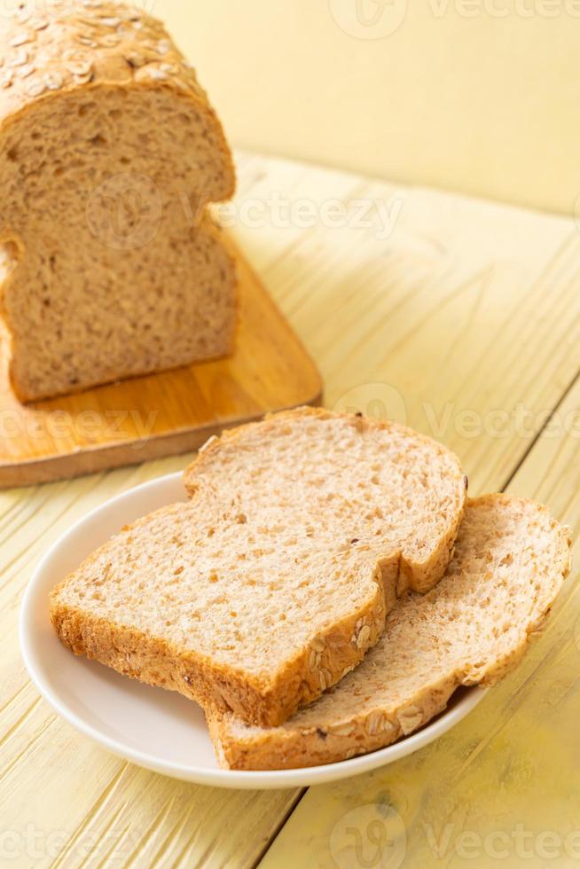 Sliced wholegrain bread on a wooden table photo
