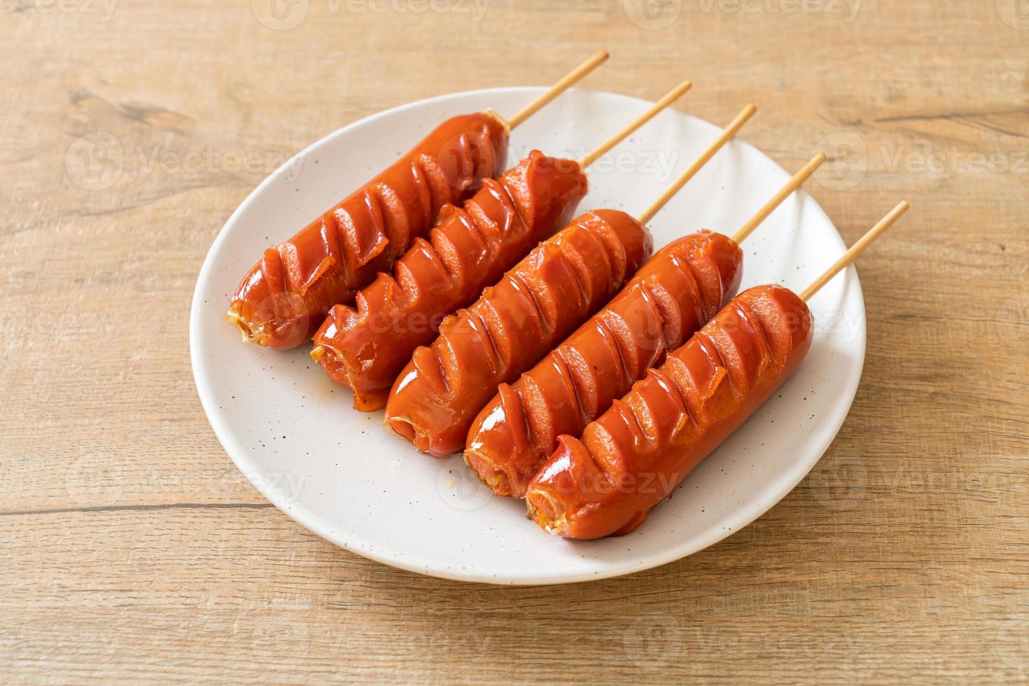 Fried sausage skewer on white plate photo