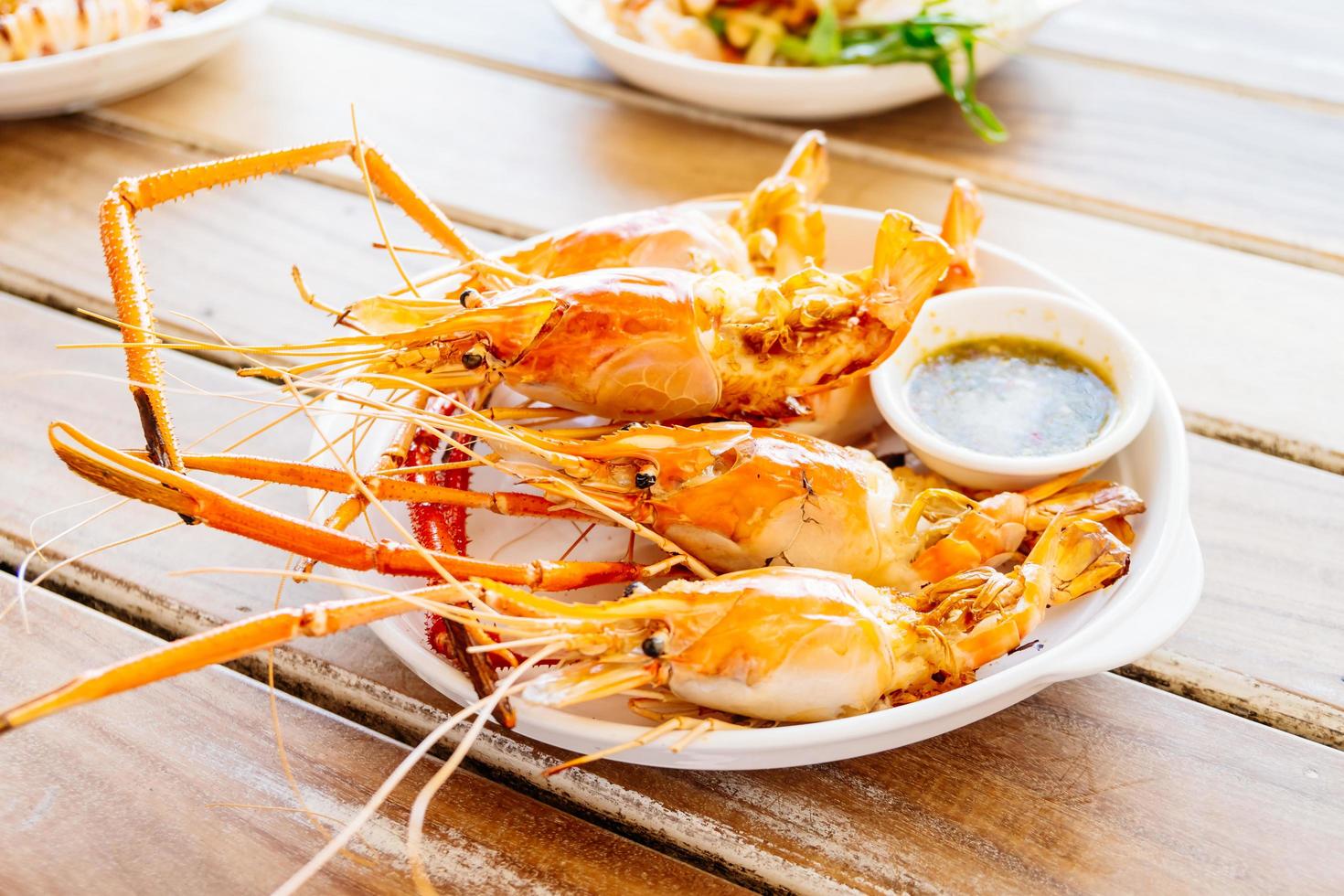 Grilled prawns with spicy seafood sauce photo