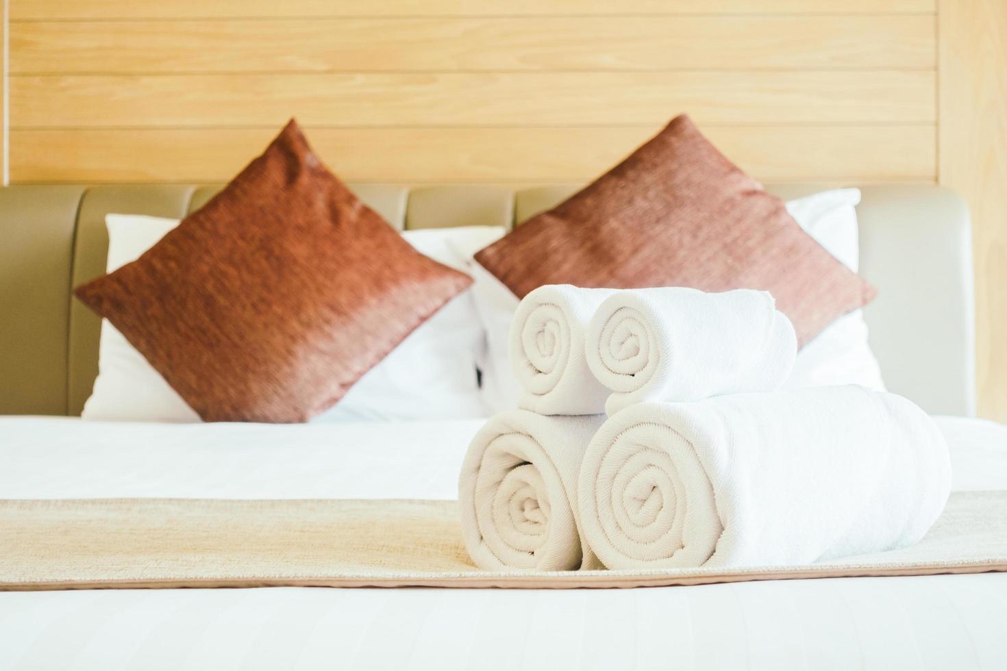 White bath towel on bed photo