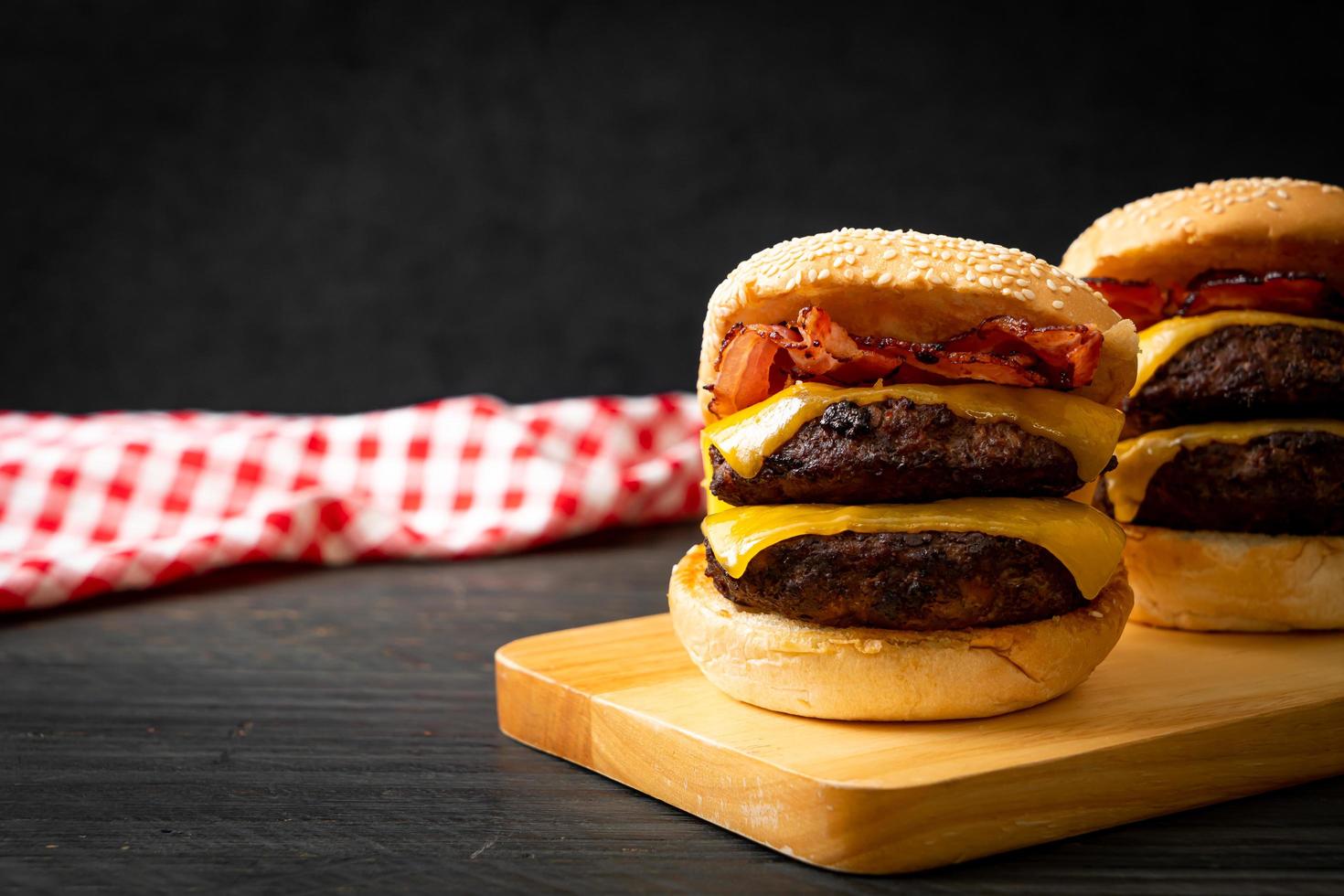 Hamburger or beef burgers with cheese and bacon - unhealthy food style photo