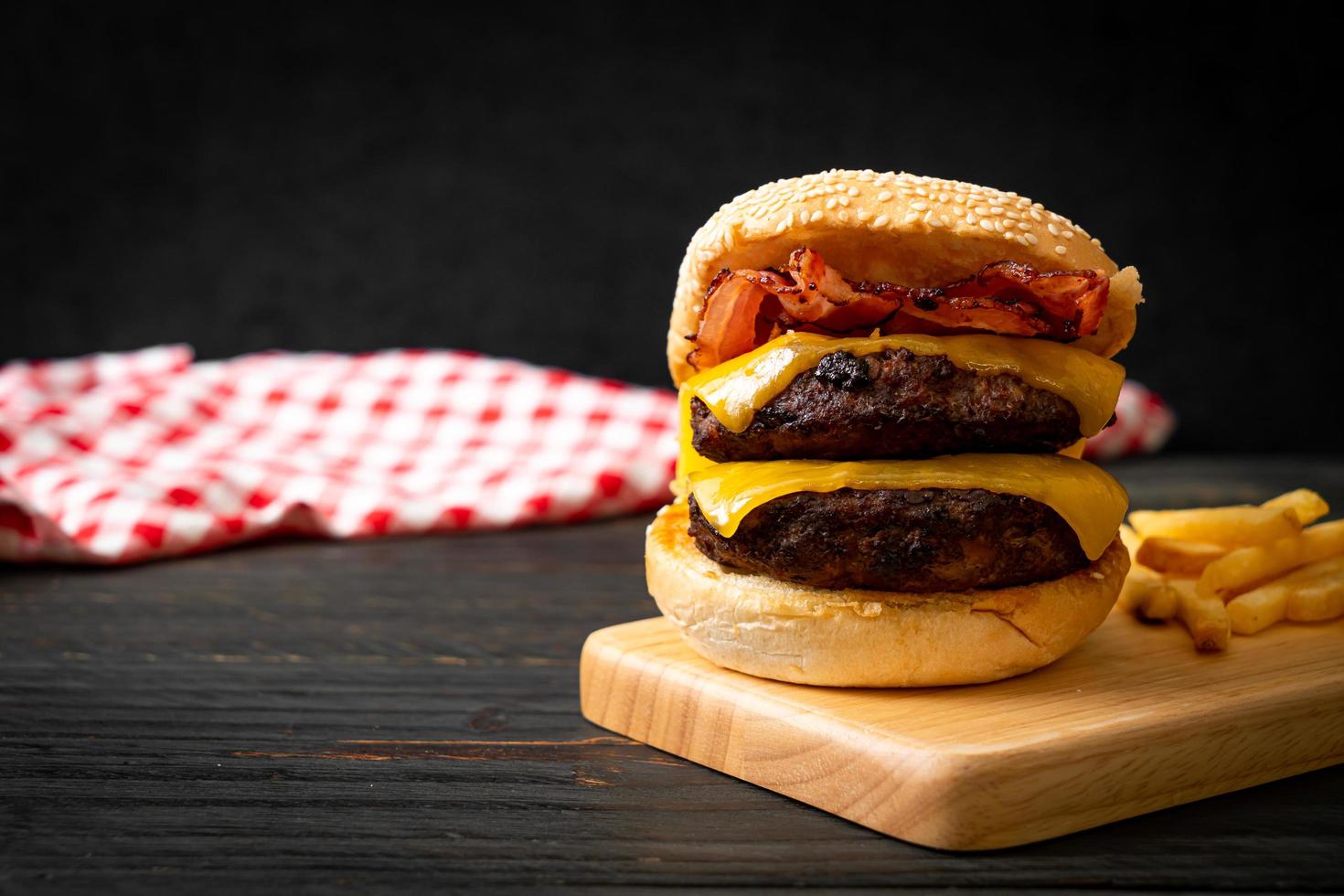 Hamburger or beef burgers with cheese and bacon - unhealthy food style photo