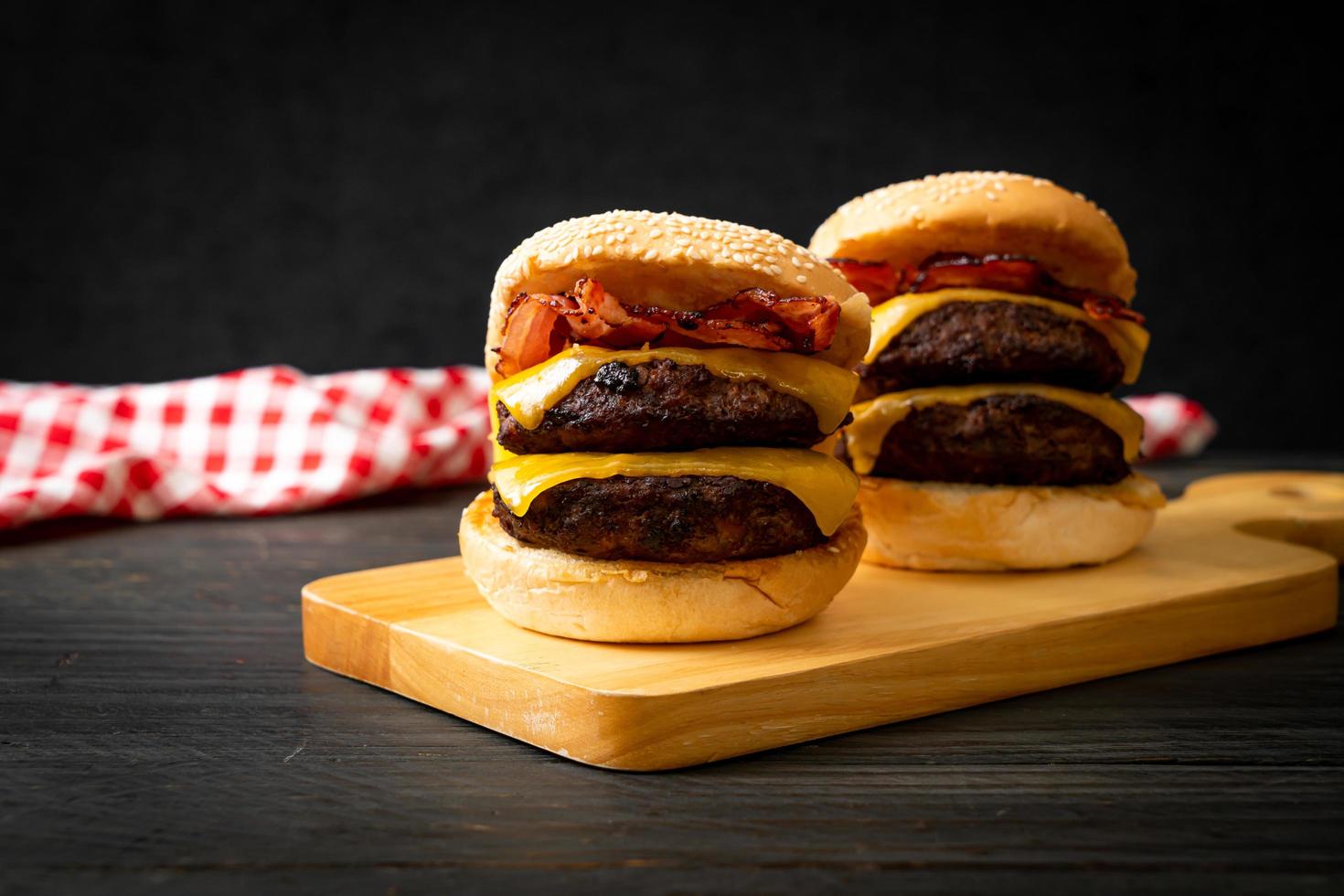 Hamburger or beef burgers with cheese and bacon - unhealthy food style photo
