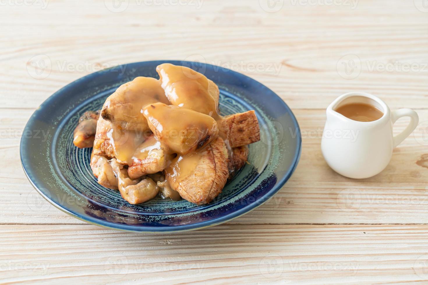 Grilled bananas with coconut caramel sauce on plate photo