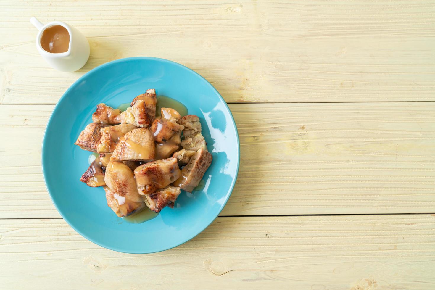 Grilled bananas with coconut caramel sauce on plate photo