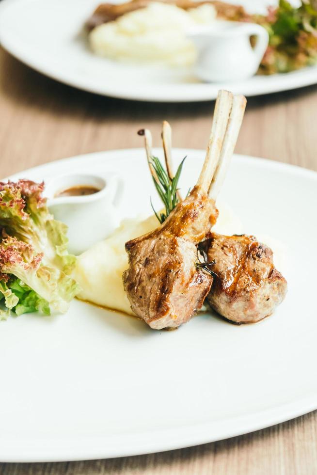 Grilled rack of lamb meat with sauce photo