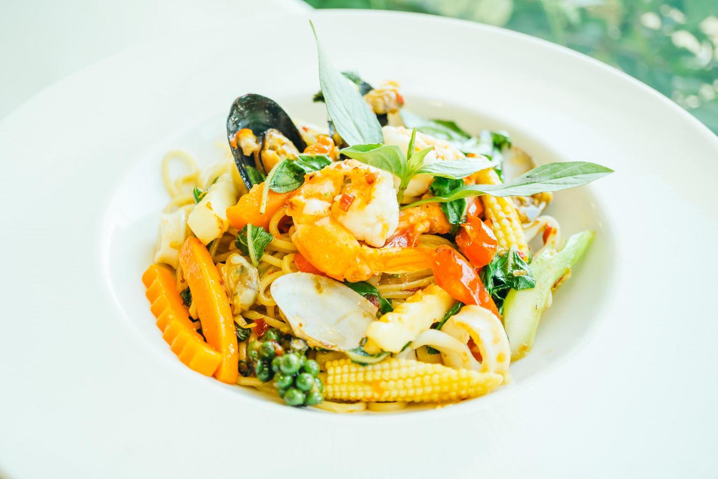 Spicy seafood spaghetti or pasta in white plate photo