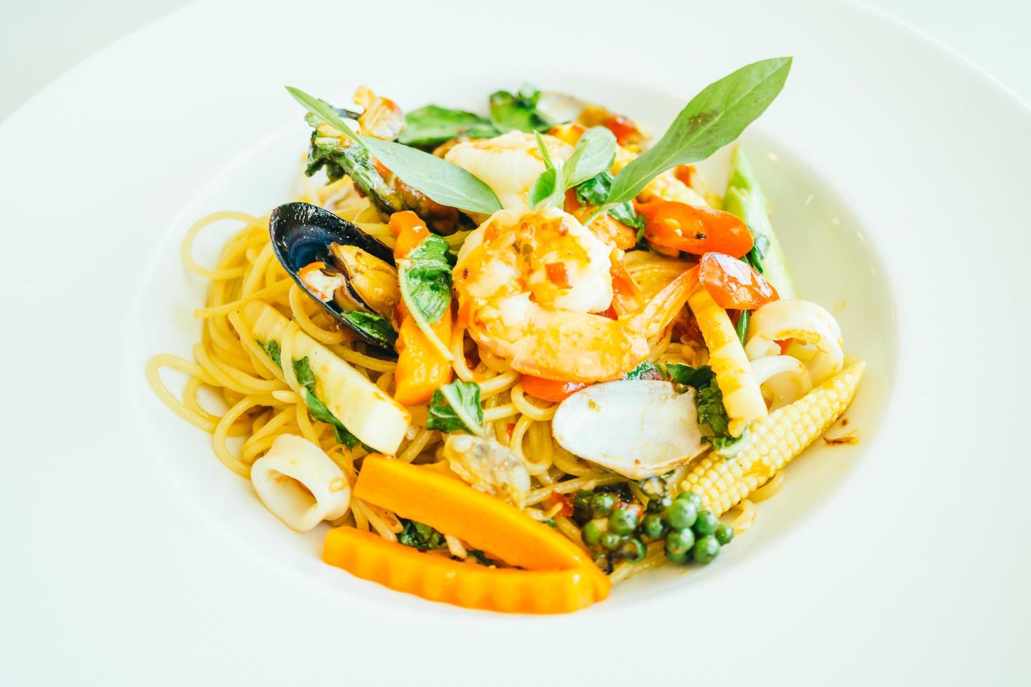 Spicy seafood spaghetti or pasta in white plate photo