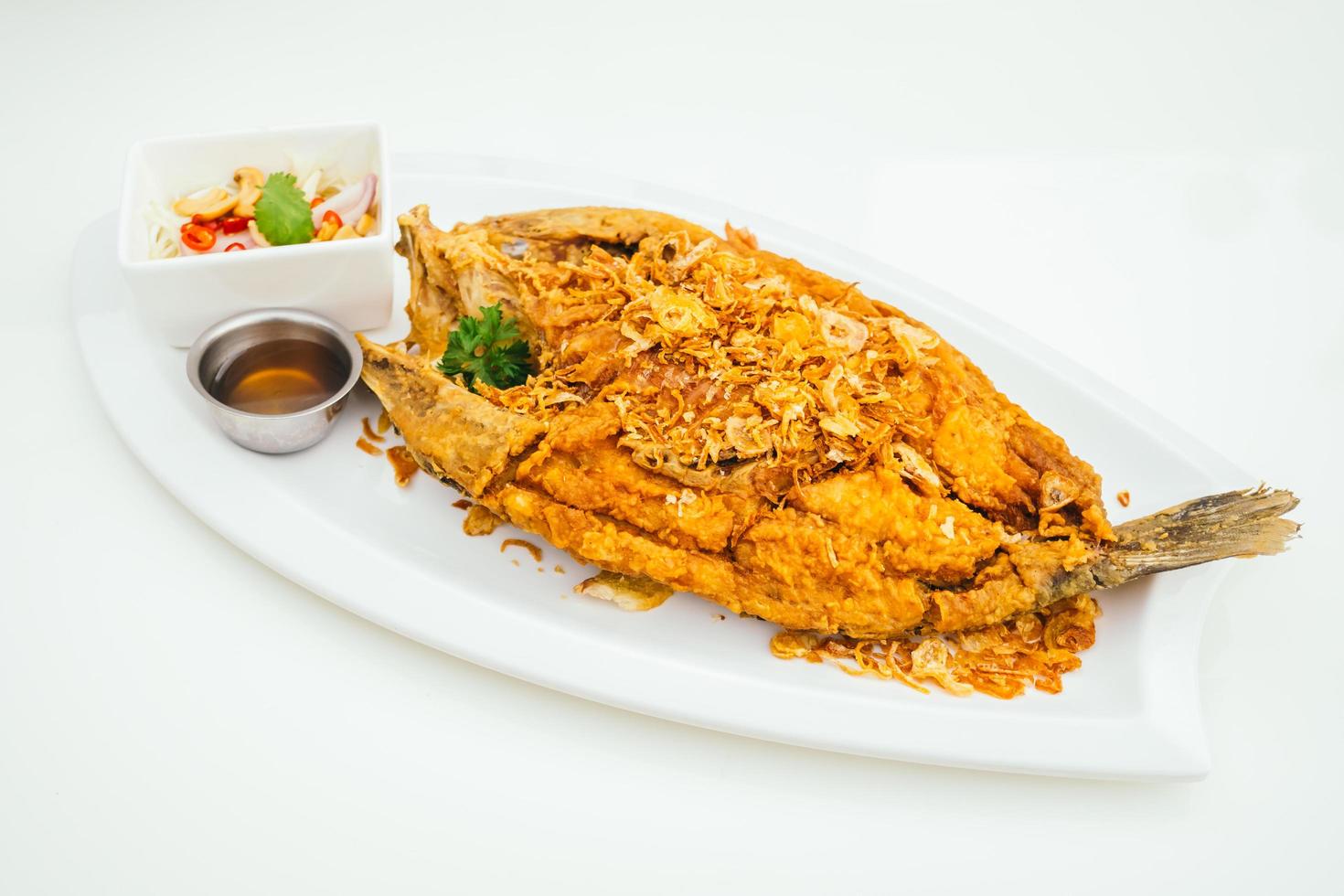 Fried sea bass meat fish with sauce photo