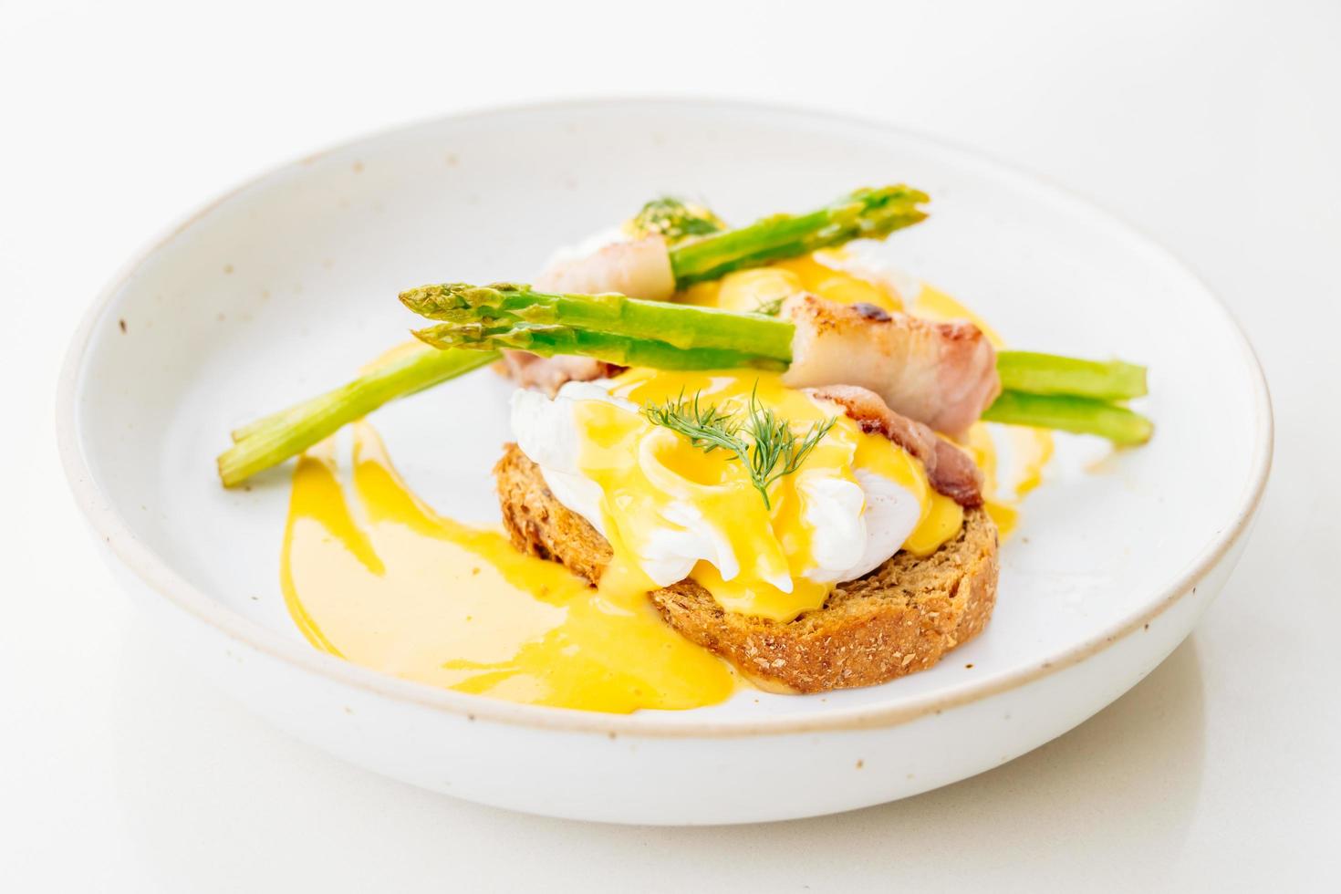 Eggs benedict with bacon twist asparagus photo