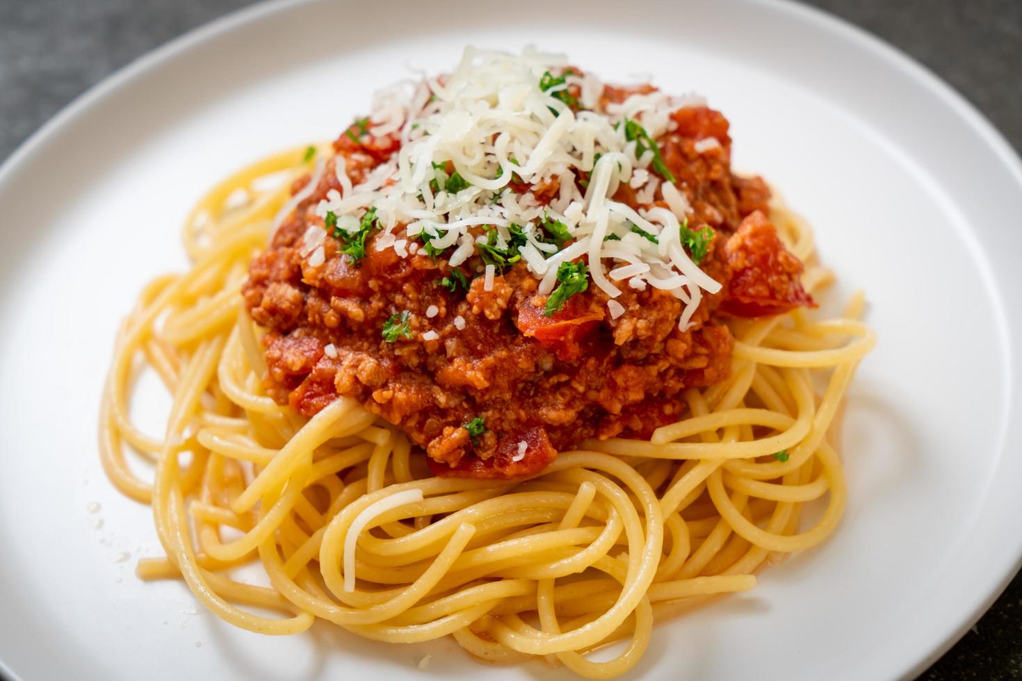 espaguetis de cerdo a la boloñesa o espaguetis con salsa de tomate de cerdo picada - estilo de comida italiana foto