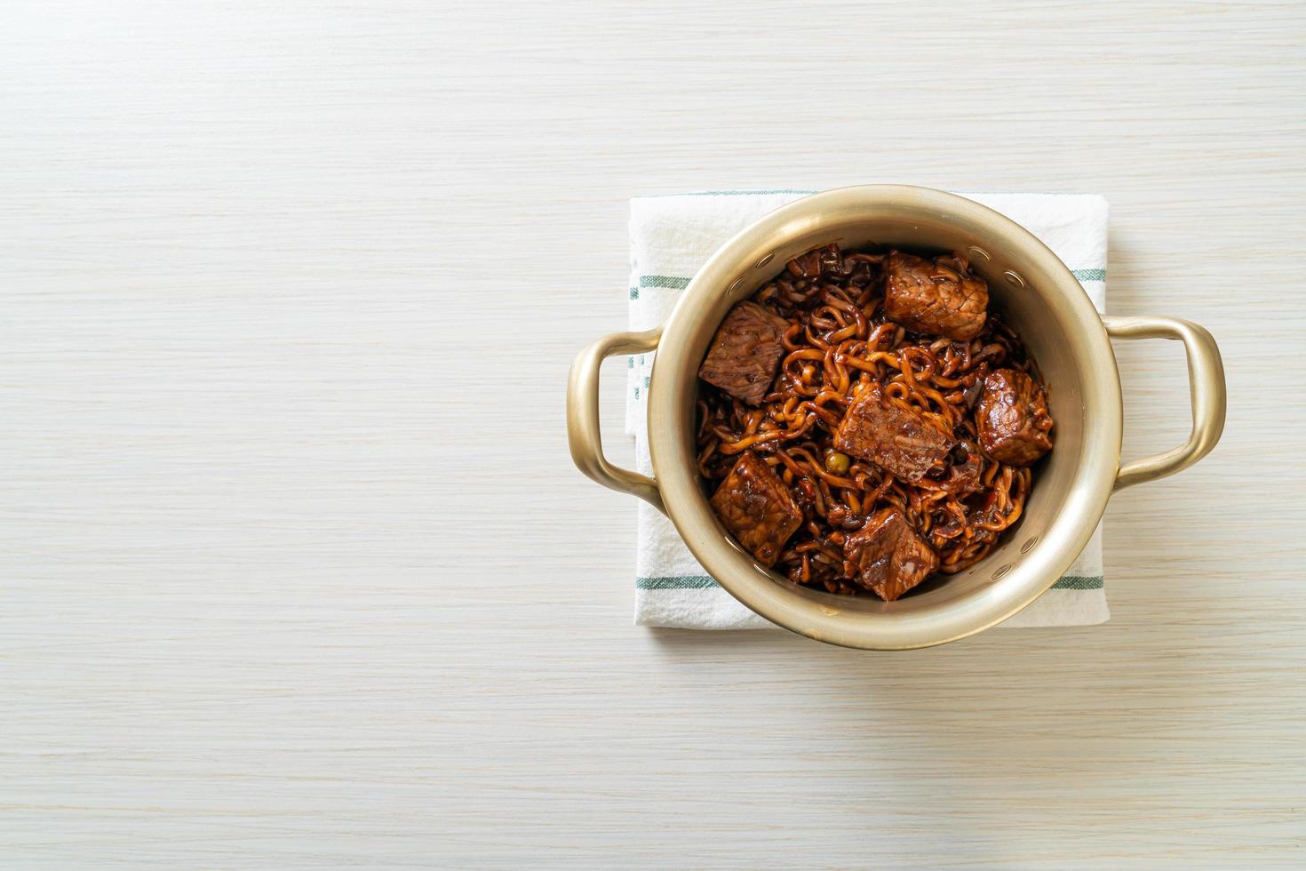 Jjapaguri or Chapaguri or Korean Black Beans Spicy Noodles with Beef photo