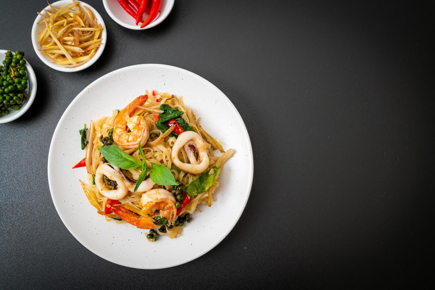 Stir-fried spicy noodles with sea food, or Pad Cha Talay - Thai food style photo