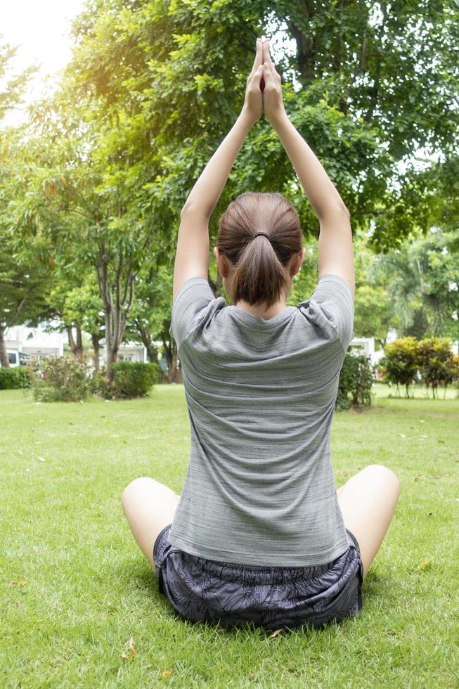 Close up of woman doing Yoga in green garden photo