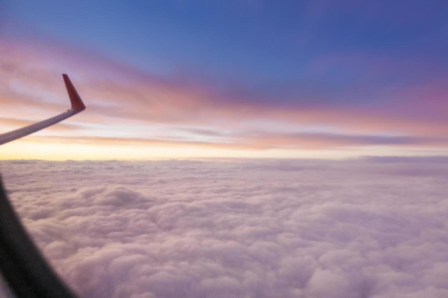 Blurred background sky at dusk view from window airplane photo