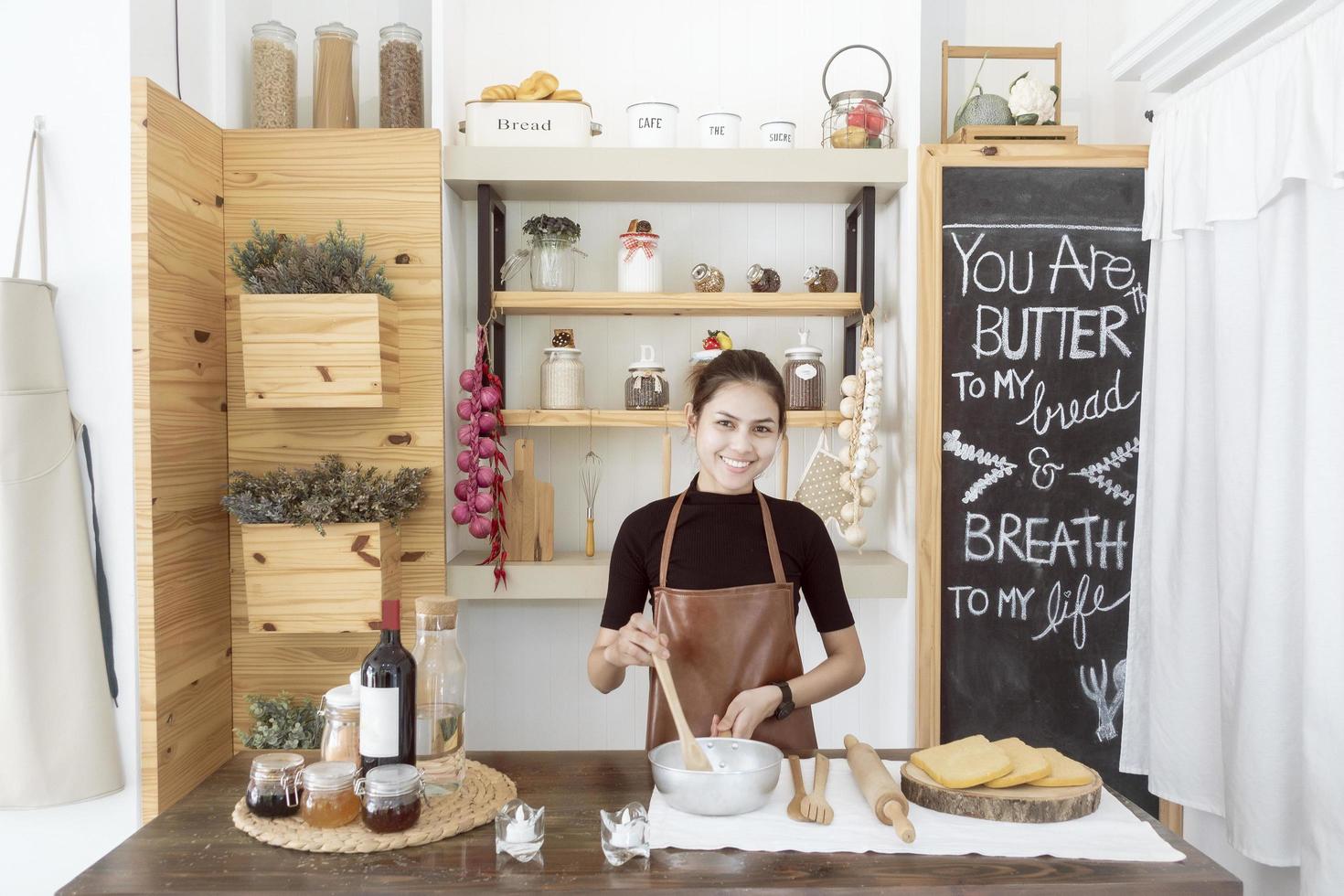 Beautiful woman is cooking in her kitchen photo