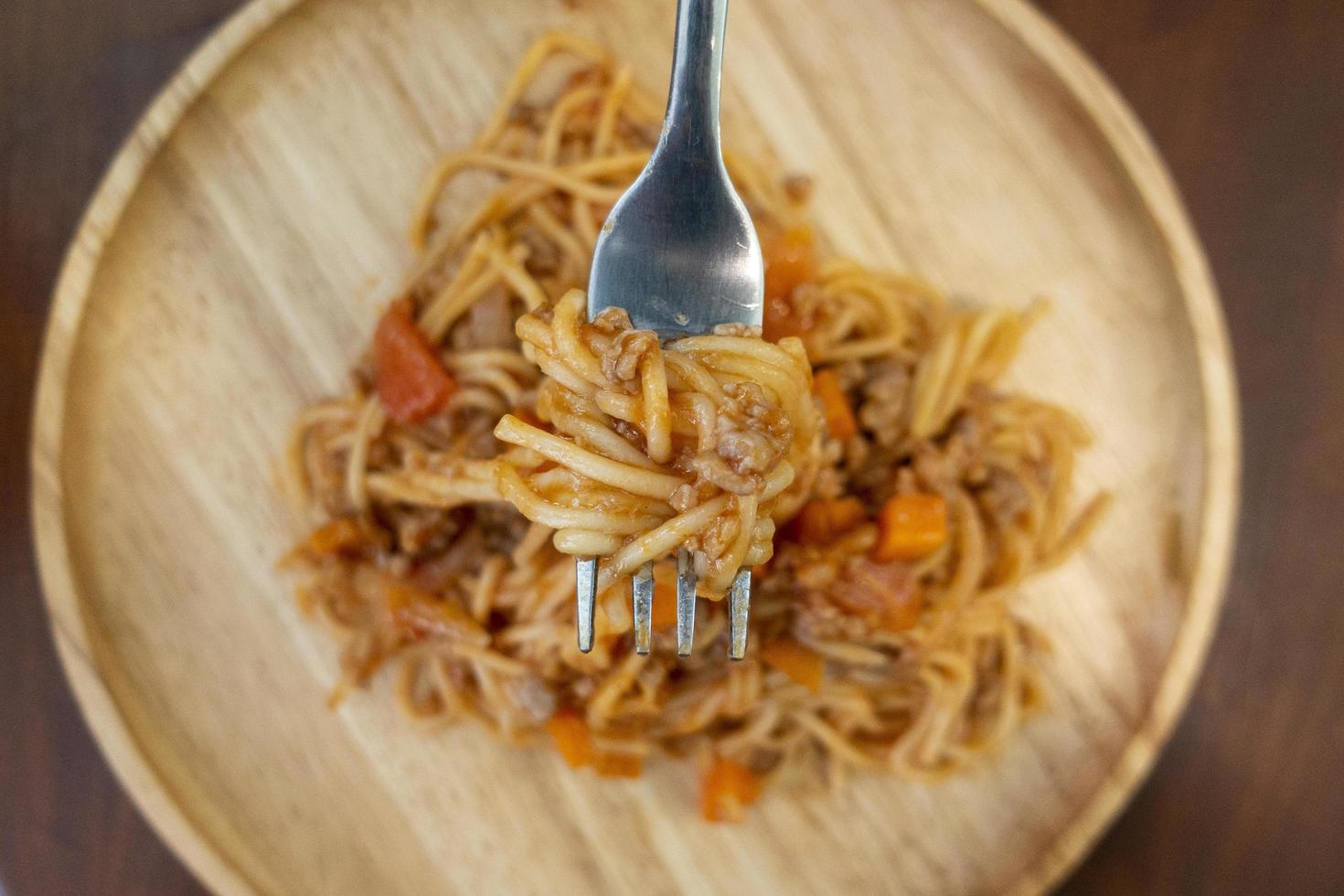 Close up of spaghetti on wooden dish photo