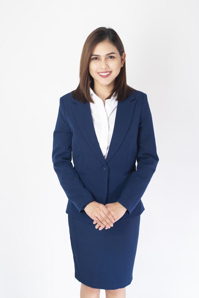 Woman in blue suit is smiling on white  background photo