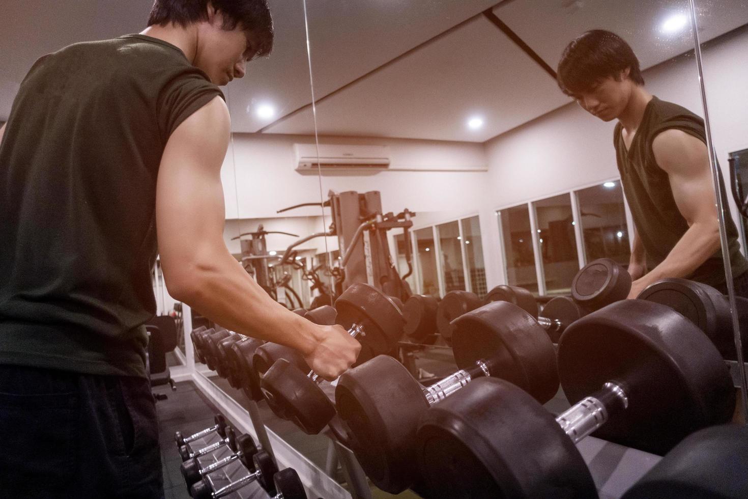 Close up of man holding weight in gym photo