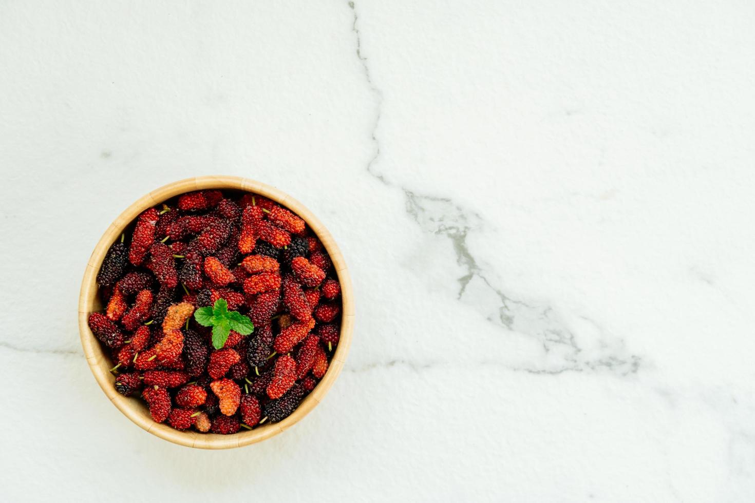 Black mulberry fruit in bowl photo