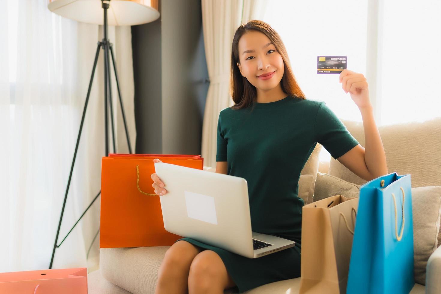 Portrait beautiful young asian women using computer laptop or smart and mobile phone with credit card for online shopping photo