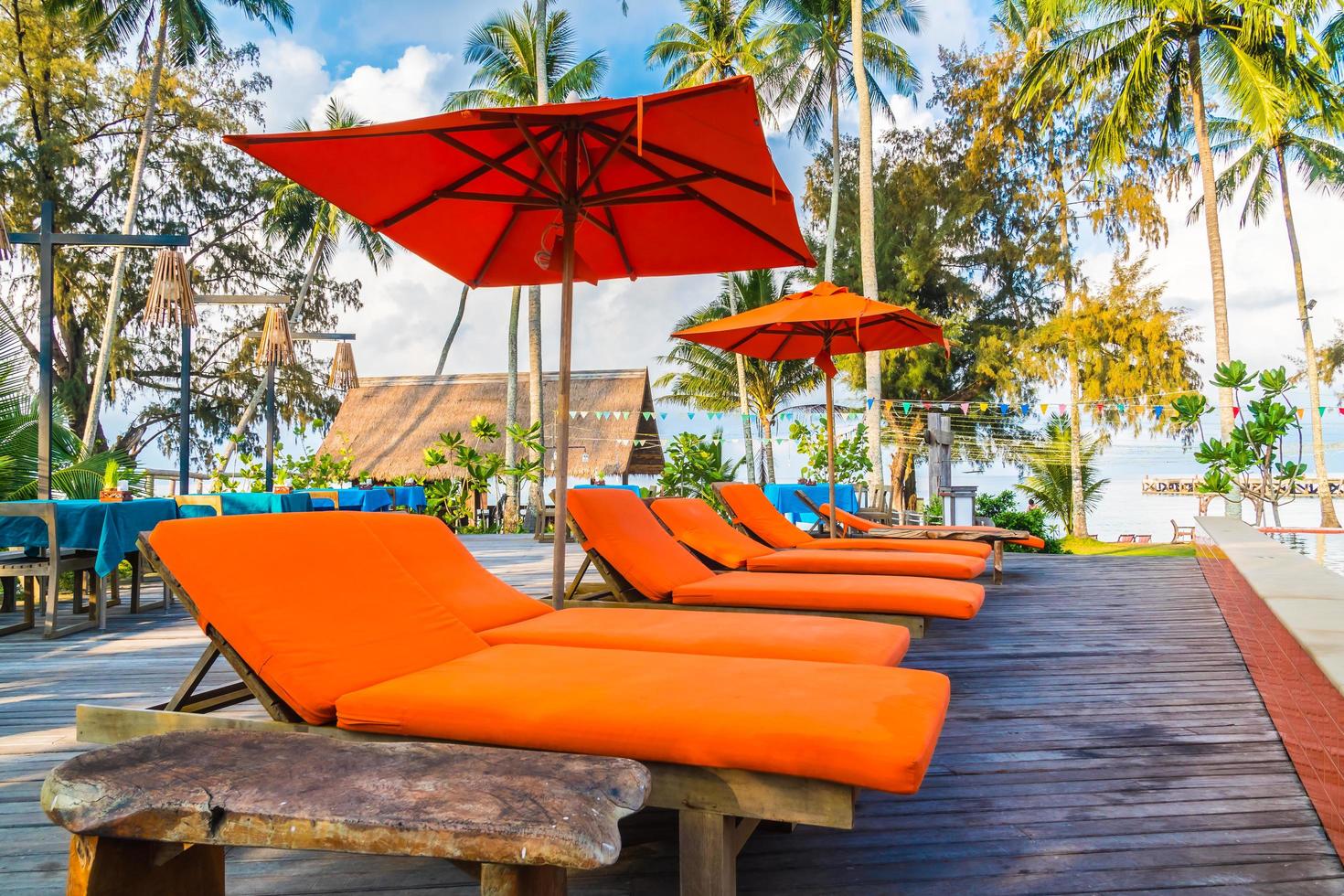 Umbrella and chair around swimming pool photo