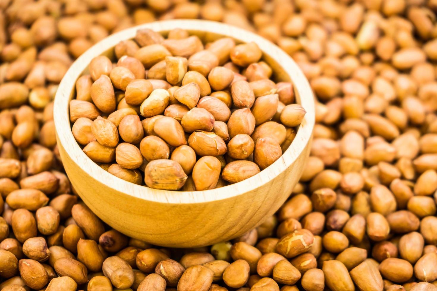 Peanuts in wooden bowl photo