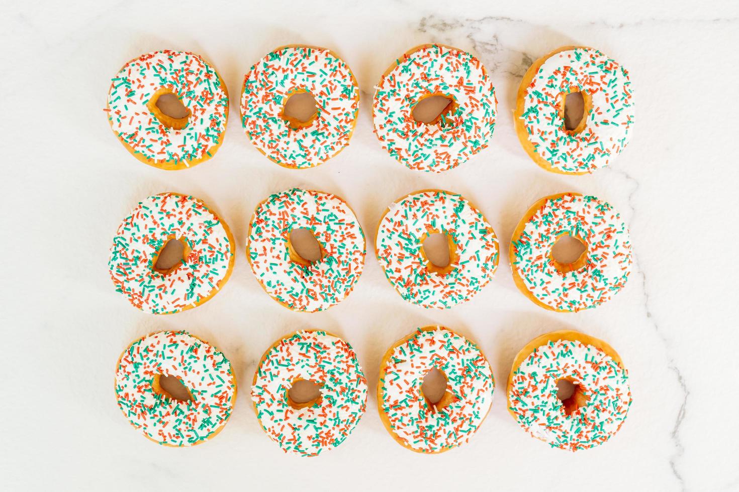 Donuts with white chocolate cream and sprinkles sugar photo