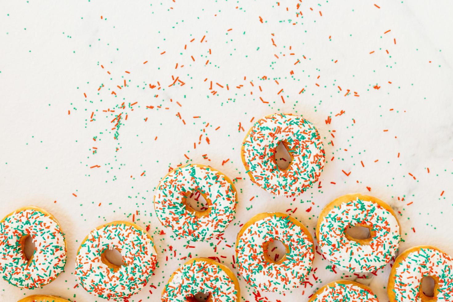 Donuts with white chocolate cream and sprinkles sugar photo