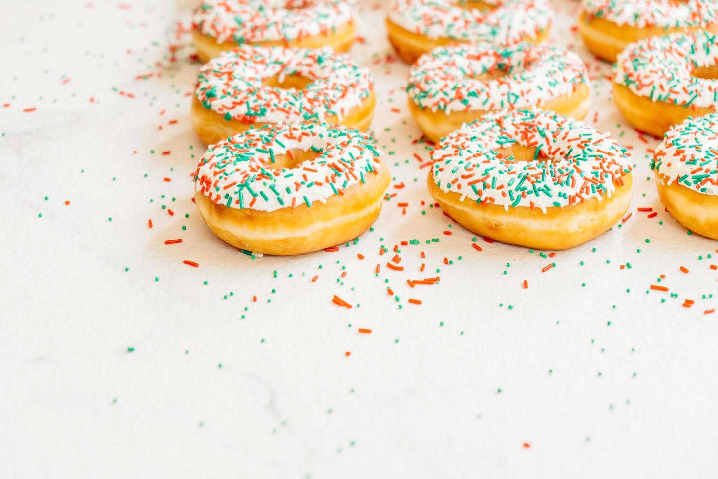 Donuts with white chocolate cream and sprinkles sugar photo