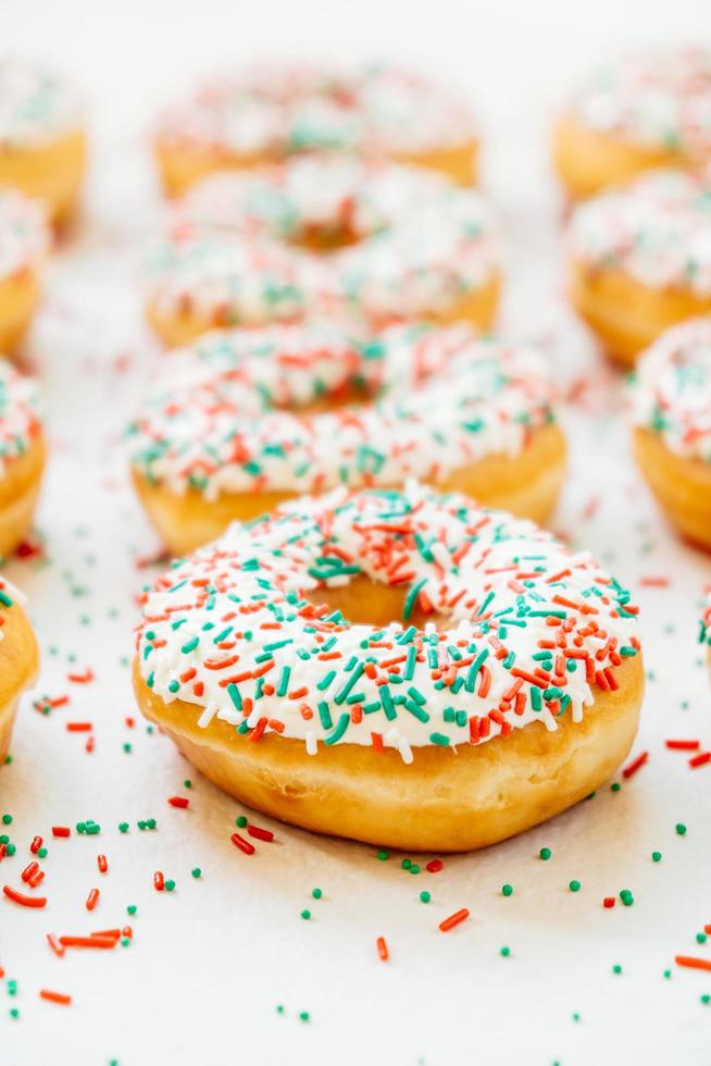 Donuts with white chocolate cream and sprinkles sugar photo