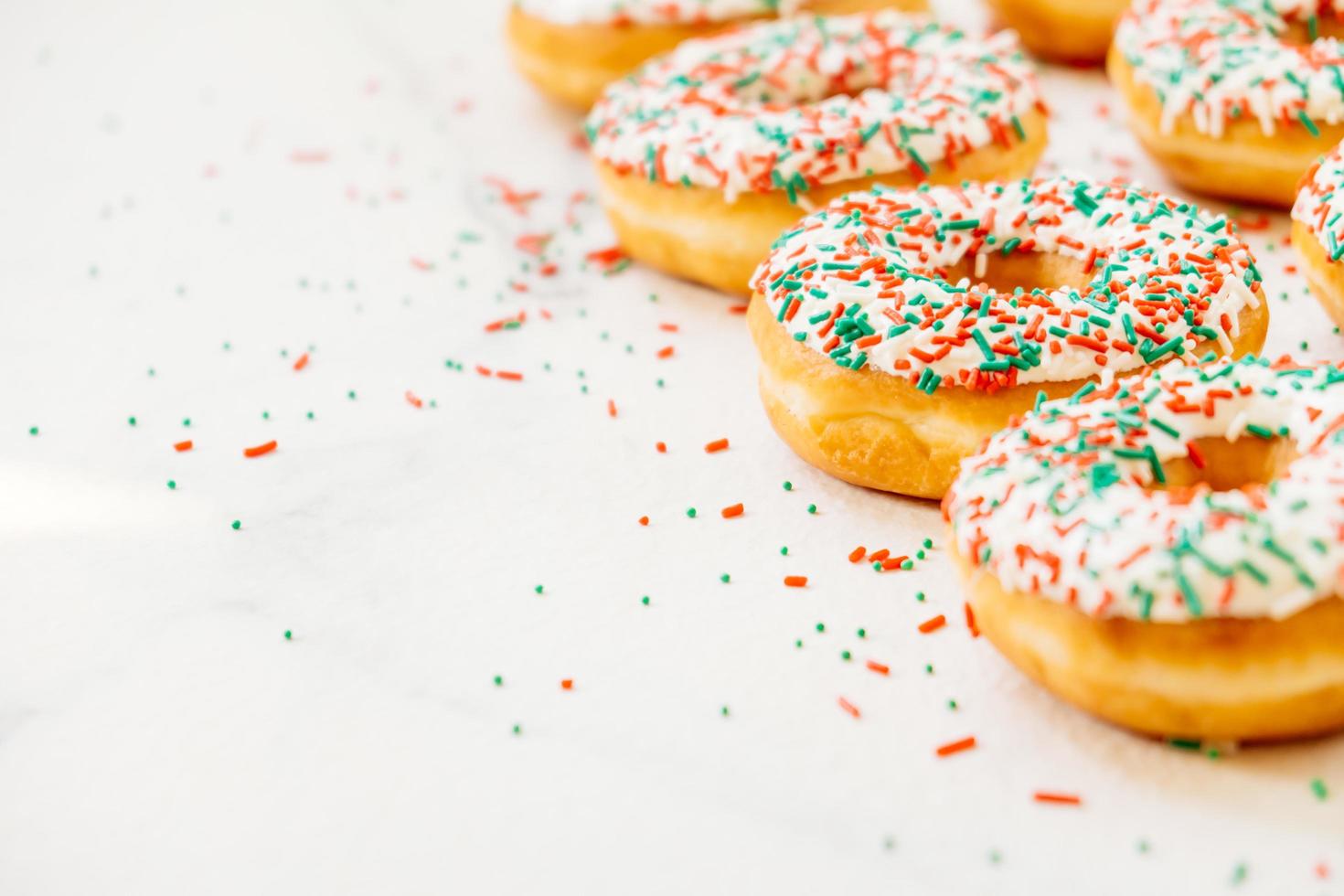 Donuts with white chocolate cream and sprinkles sugar photo