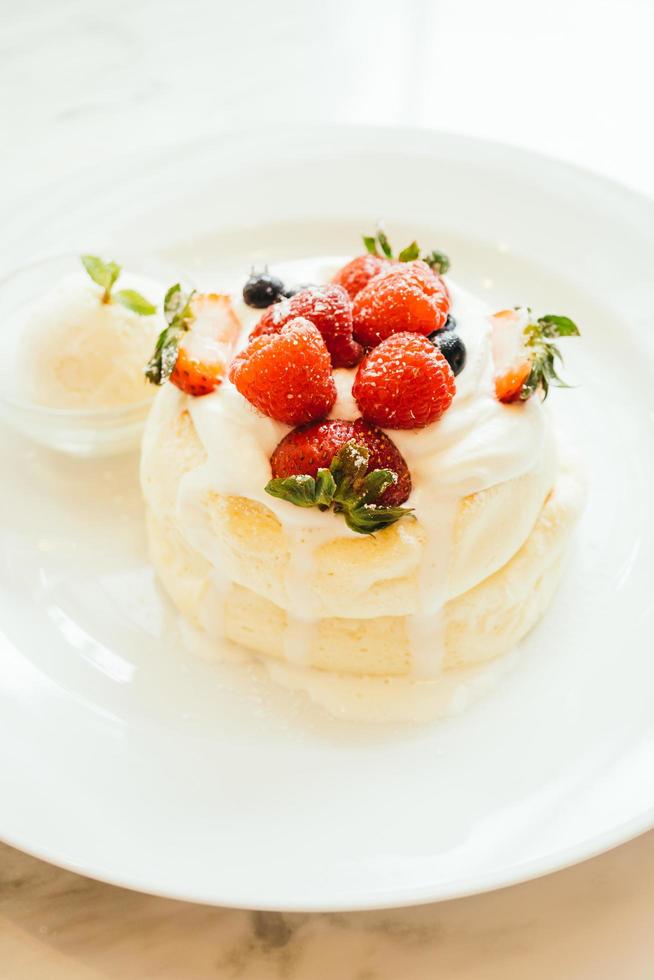 Pancake with ice cream strawberry , blueberry and raspberry photo