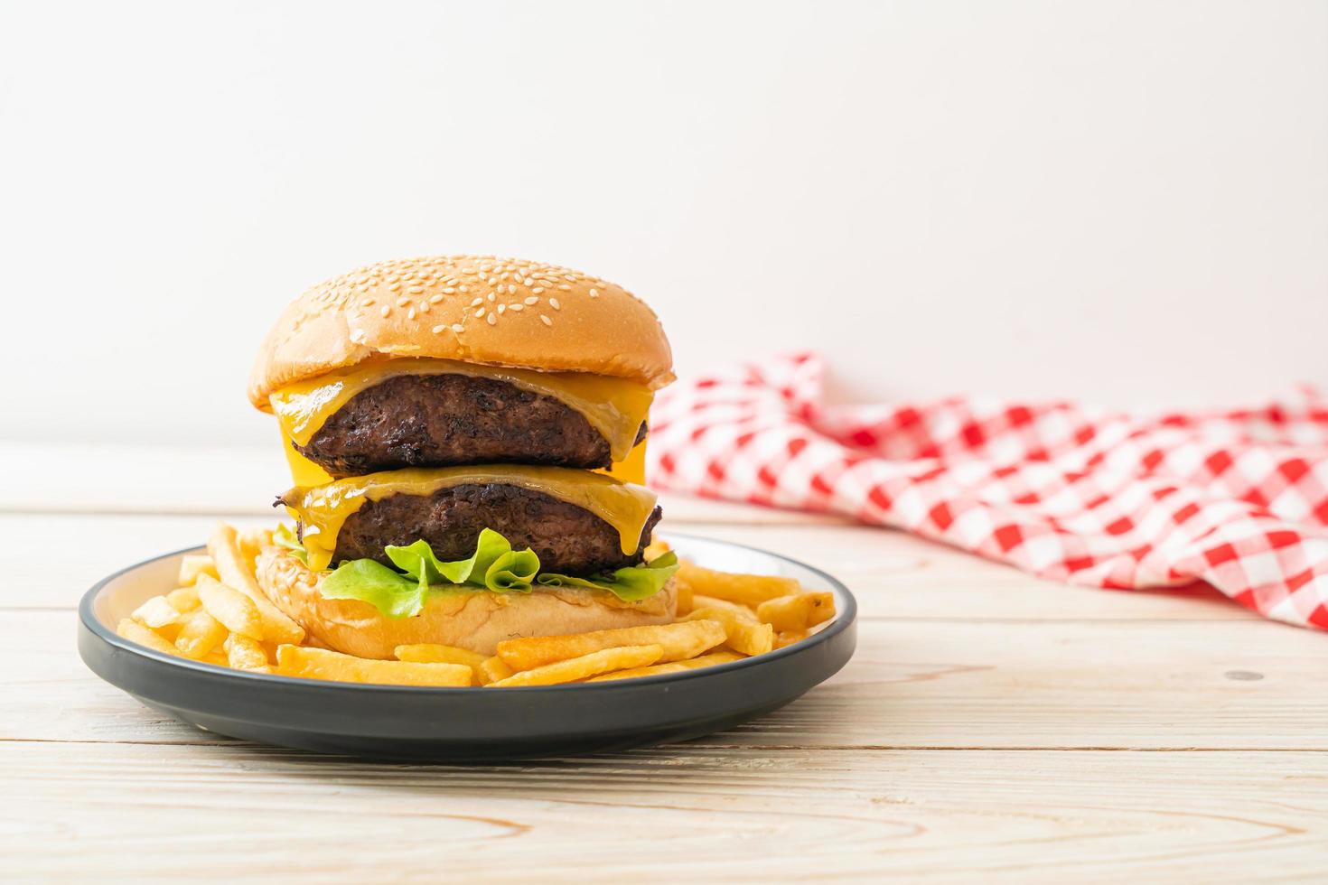 Hamburger or beef burgers with cheese and french fries - unhealthy food style photo