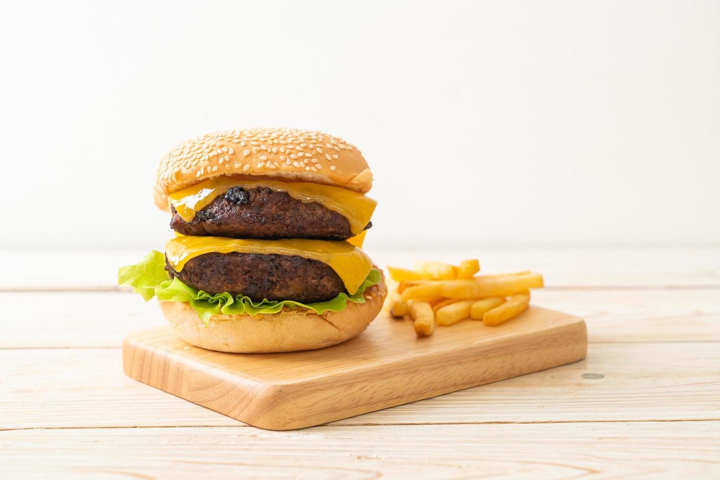 Hamburger or beef burgers with cheese and french fries - unhealthy food style photo