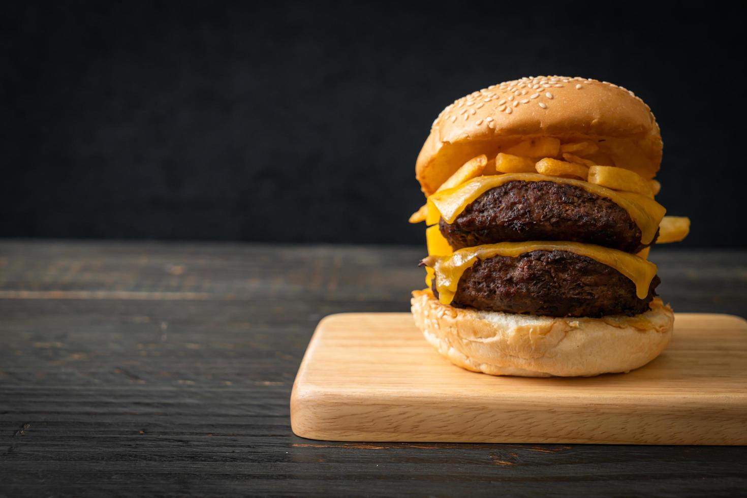 Hamburger or beef burgers with cheese and french fries - unhealthy food style photo