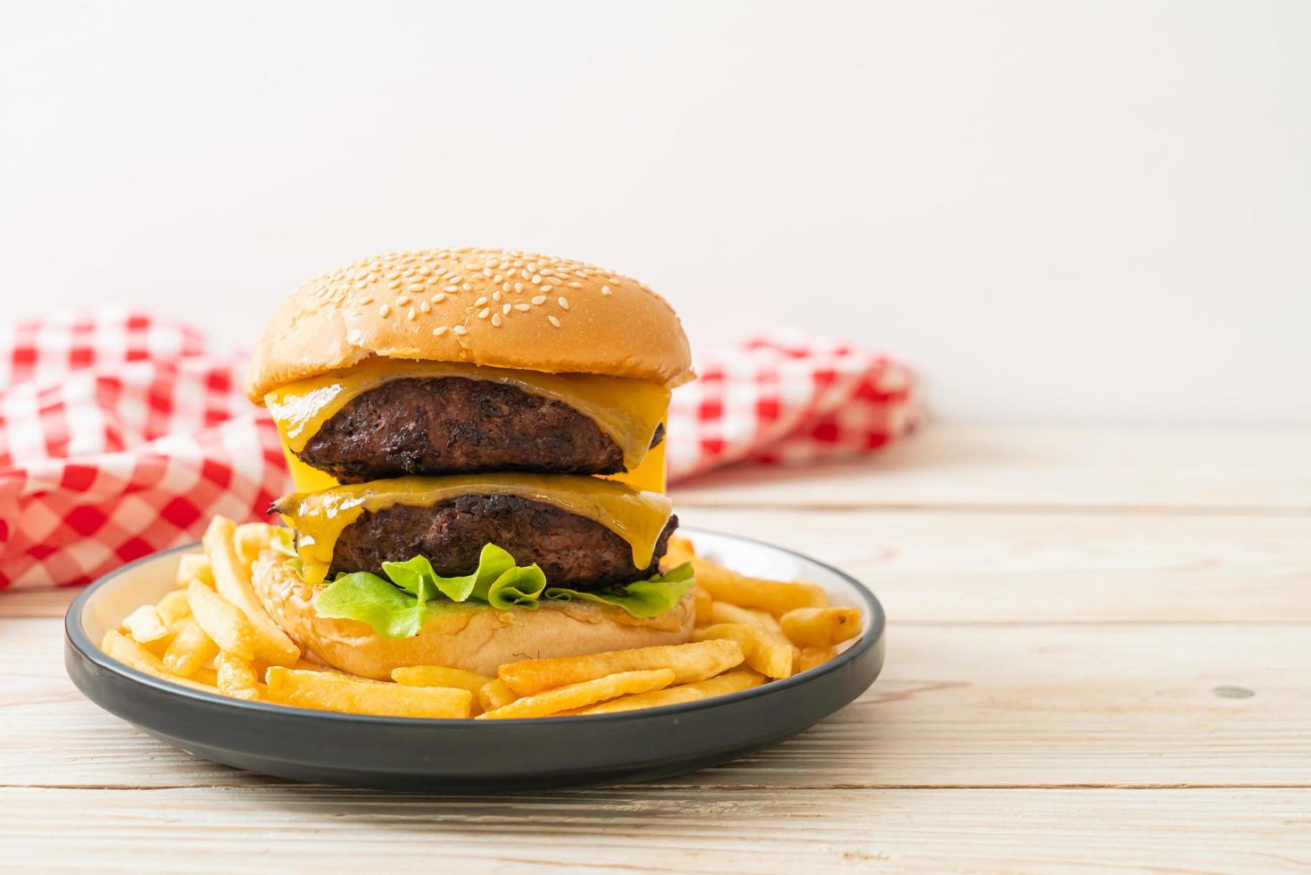 Hamburger or beef burgers with cheese and french fries - unhealthy food style photo