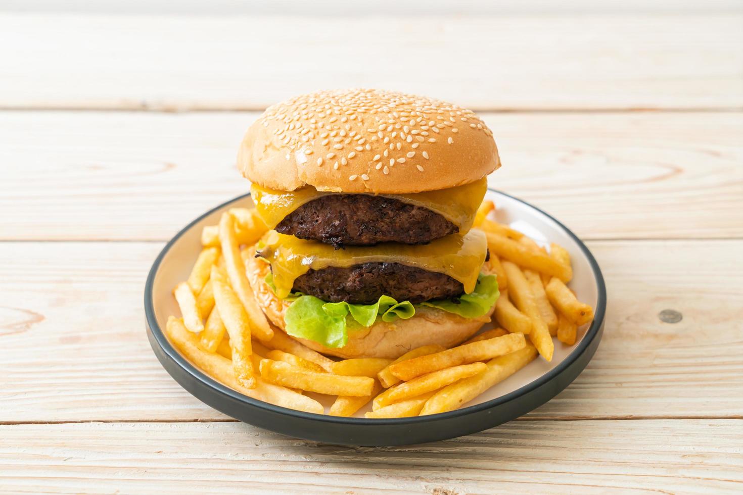 Hamburger or beef burgers with cheese and french fries - unhealthy food style photo