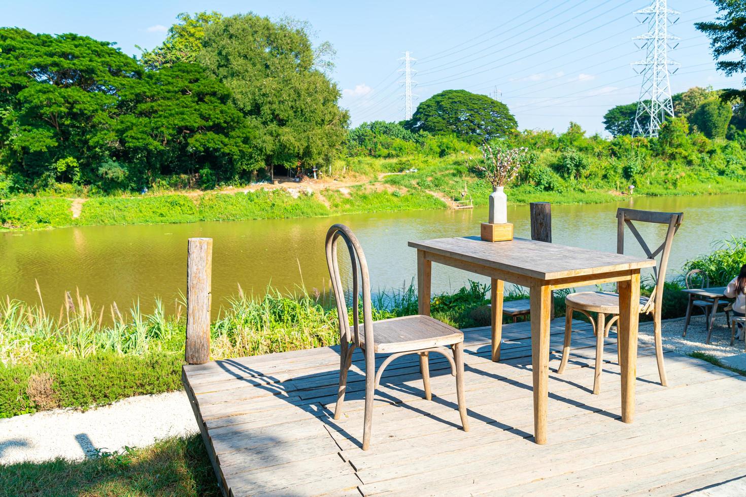 Empty table and chair with river view and blue sky photo