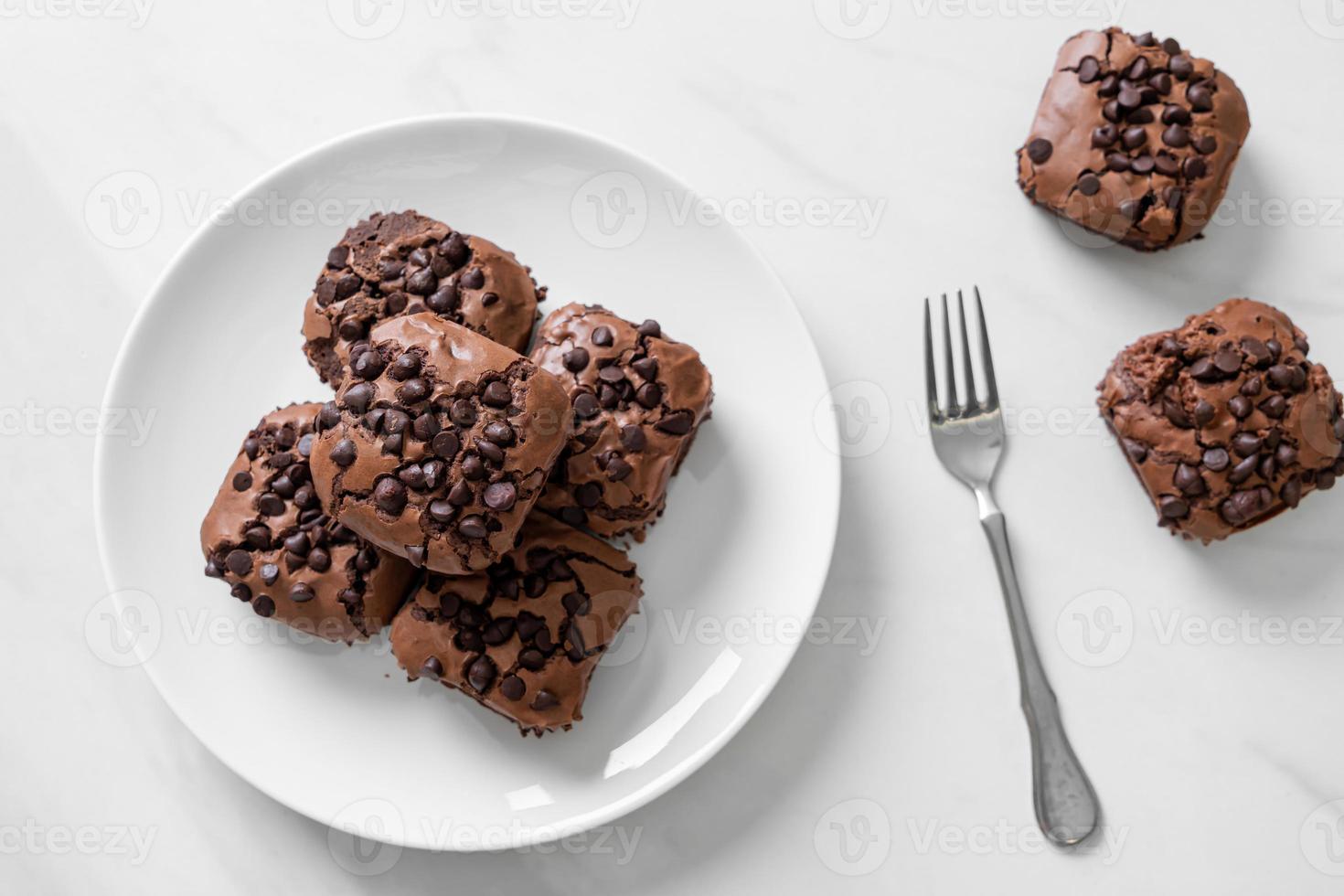 Dark chocolate brownies with chocolate chips on top photo