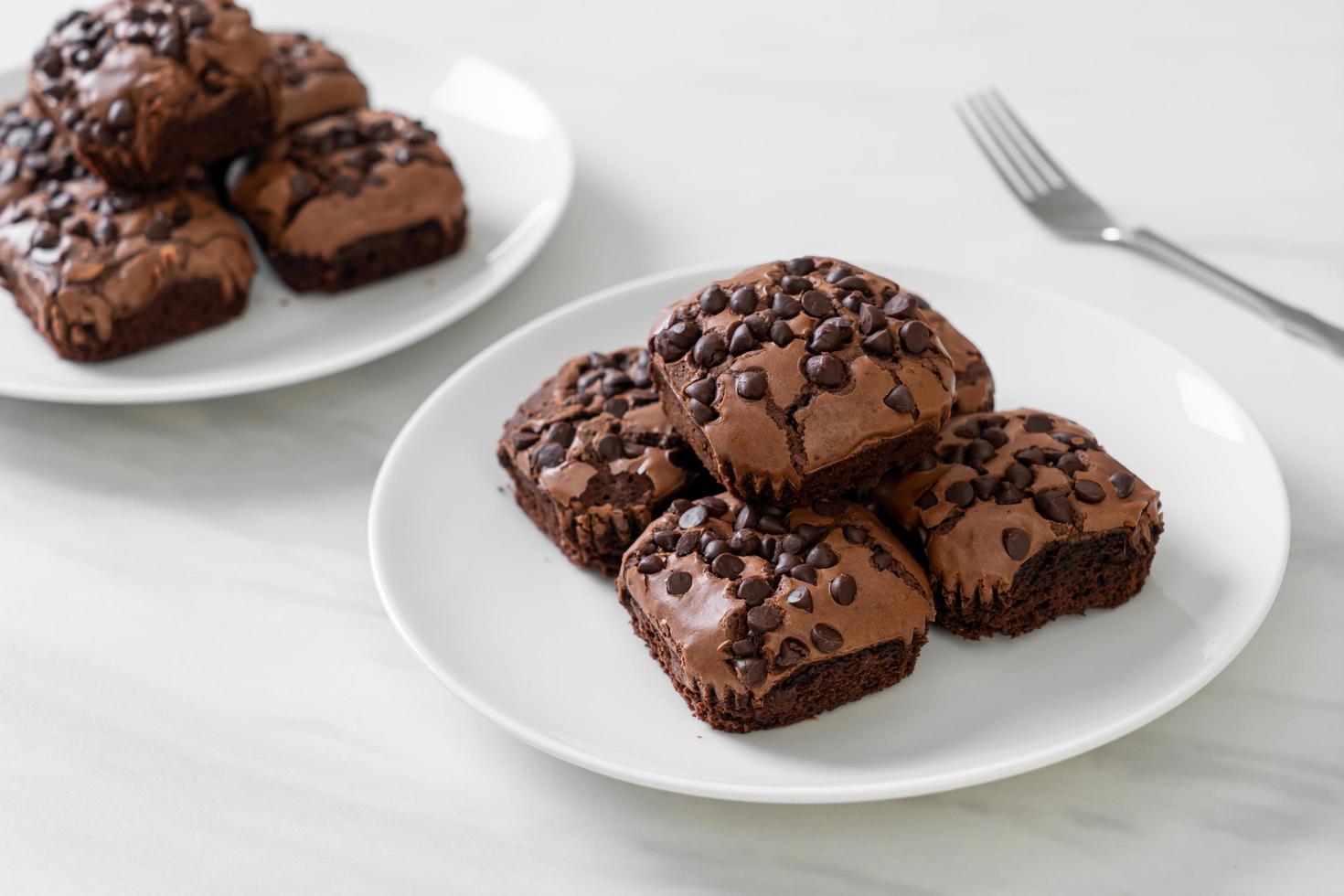 Dark chocolate brownies with chocolate chips on top photo