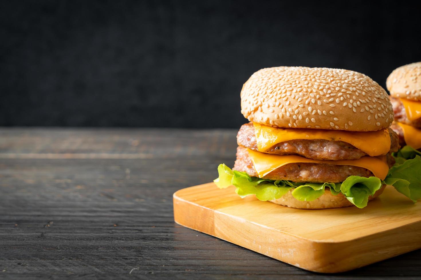 Pork hamburger or pork burger with cheese on wooden board photo