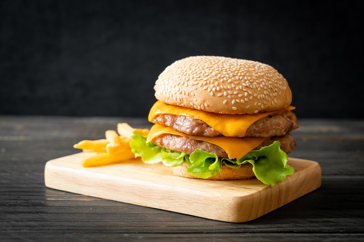 Pork hamburger or pork burger with cheese and french fries photo