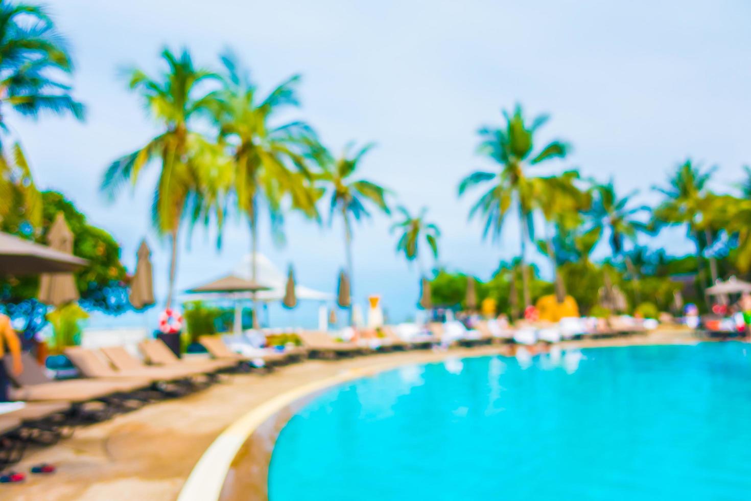 Abstract blur coconut palm tree around swimming pool photo